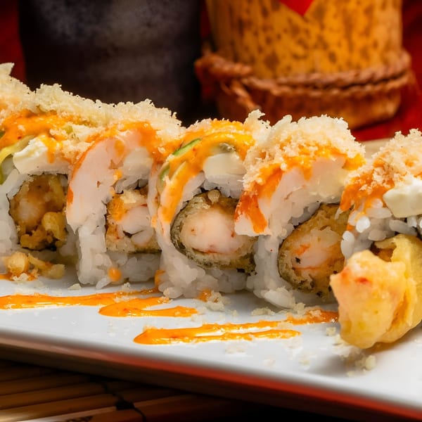Samurai Sushi's crispy shrimp tempura rolls with spicy mayo and crunchy topping on a white plate.